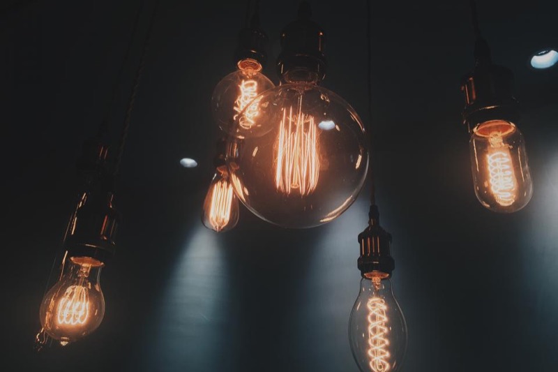 Hanging filament bulbs glowing in a dark room