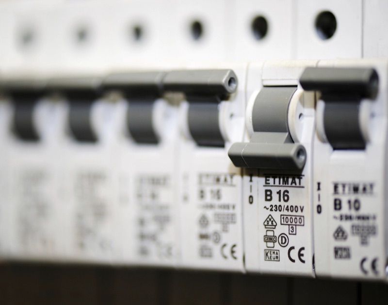 Row of circuit breakers in a panel with one switched off